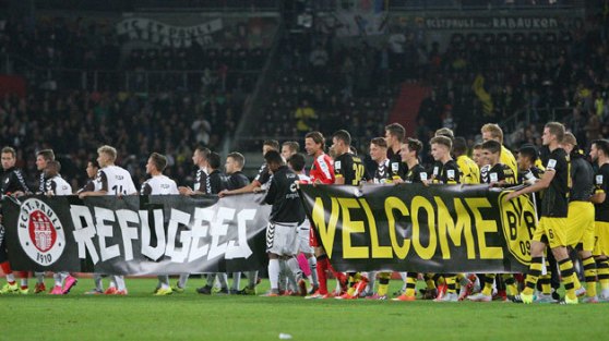 Soccer fans and clubs across Europe, particularly in Germany and especially F.C. St. Pauli, are extending a warm welcome and a helping hand to the thousands of refugees.